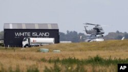 A Navy helicopter hovers at Whakatane Airport, as the recovery operation to return the victims of the Dec. 9 volcano eruption continues off the coast of Whakatane New Zealand, Dec. 13, 2019.