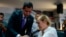 Venezuelan opposition leader and self-proclaimed acting president Juan Guaido (L) comforts oncological patient Mildred Valera during a special consultation commission meeting at the National Assembly building in Caracas on August 27, 2019. / AFP /…