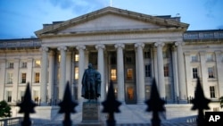 FILE - The U.S. Treasury Department building at dusk in Washington. 