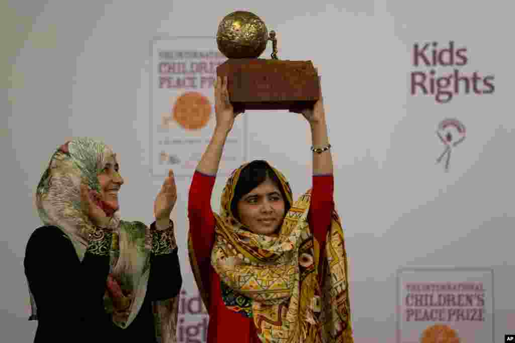 Pakistani teenager Malala Yousafzai, right, who was shot and injured by the Taliban for advocating girls' education, is awarded the International Children's Peace Prize 2013 by 2011 Nobel Peace Prize winner Tawakkol Karman of Yemen, left, during a ceremony in the Hall of Knights in The Hague, Netherlands.