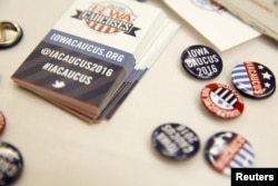 FILE - Buttons for visitors at the Greater Des Moines Partnership Iowa Caucus Consortium candidate forum are seen before a visit by U.S. Republican presidential candidate Jeb Bush in Des Moines, Iowa, Oct. 8, 2015.