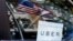 FILE - An Uber sign is seen in a car in New York, NY, U.S.