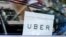 FILE - An Uber sign is seen in a car in New York, NY, U.S.