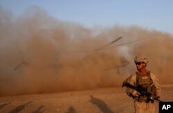 FILE - A U.S. Marine takes part during a training session for Afghan army commandos in Shorab military camp in Helmand province, Afghanistan, Aug. 27, 2017.