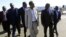 Sudan's top negotiator Idris Abdel-Qadir (front L) welcomes South Sudan's chief negotiator Pagan Amum (front R) at Khartoum Airport, December 1, 2012.