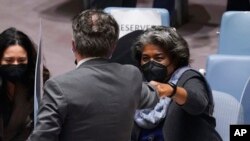 Ukraine's United Nations Ambassador Sergiy Kyslytsya, center, fist-bumps U.S. Ambassador Linda Thomas-Greenfield, left, after a Security Council meeting at U.N. headquarters, Jan. 31, 2022.