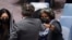 Ukraine's United Nations Ambassador Sergiy Kyslytsya, center, fist-bumps U.S. Ambassador Linda Thomas-Greenfield, left, after a Security Council meeting at U.N. headquarters, Jan. 31, 2022.