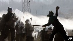 Kosovo Serbs clash with German army soldiers serving under the auspices of the NATO peacekeeping mission in Kosovo, as the NATO troops work to remove a roadblock near the village of Jagnjenica, Kosovo, November 28, 2011.