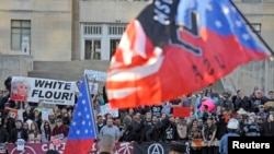 FILE - Counter-protesters yell across the street at city hall during a neo-Nazi rally at the Jackson County Courthouse in Kansas City, Missouri, Nov. 9, 2013.