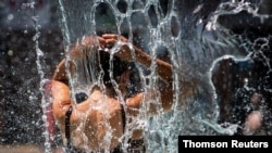 A woman cools off in a public pool during an unprecedented heat wave in Portland, Oregon, June 27, 2021.