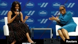 U.S. first lady Michelle Obama and television presenter Oprah Winfrey participate in the White House's "United State of Women" summit in Washington, June 14, 2016.