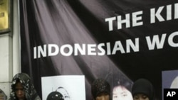 Indonesian activists wear the names of four Indonesian women, who were allegedly tortured by their employers in Saudi Arabia, stand in front of the Saudi Arabian Embassy during a demonstration, Aug. 13, 2007 in Jakarta, Indonesia.