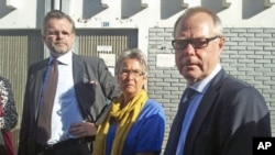 Kjell Persson (R) and Christina Persson (C), parents of Swedish photographer Johan Persson and Swedish ambassador to Ethiopia Jens Odlander (R), stand outside the courtroom in Ethiopia's capital Addis Ababa, December 21, 2011.