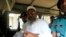 Bangladesh's Jamaat-e-Islami leader Abdul Quader Mollah gestures as he talks from a police van after a war crimes tribunal sentenced him to life imprisonment in Dhaka February 5, 2013. A controversial war crimes tribunal sentenced a senior leader of Bangl