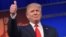 Real estate tycoon Donald Trump flashes the thumbs-up as he arrives on stage for the start of the prime time Republican presidential debate on Aug. 6, 2015 at the Quicken Loans Arena in Cleveland, Ohio.