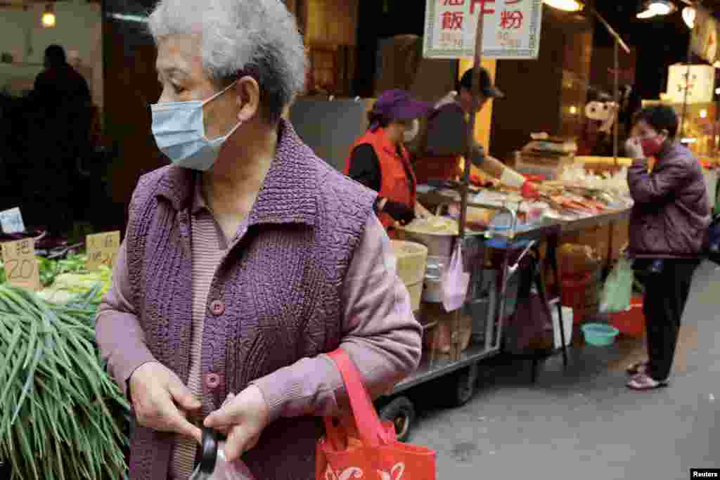 Los residentes usan mascarillas para protegerse de la propagación de la enfermedad por coronavirus (COVID-19) mientras compran en un mercado al aire libre en Taipei, Taiwán.