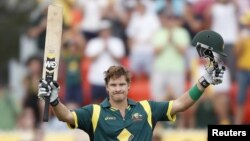 Members of the class of the New York City Police Academy raise hands during their graduation ceremony at Madison Square Garden in New York.