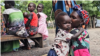 A mother and her child sit patiently, waiting for their turn to receive ready-to-eat therapeutic food at Koat Nutrition Center in Akobo East, South Sudan. (Sheila Ponnie/VOA)