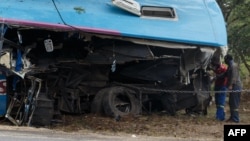 FILE: People inspect the wreckage of one of two buses that collided Nov. 7, 2018, along the Harare-Mutare highway near Rusape, Zimbabwe, Nov. 8, 2018.