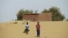 FILE - Boys walk on desert sands in the town of Moghtar-Lajjar in west Africa's Sahel region, where the United Nations says civil unrest and a drought have put 18 million people in food insecurity, May 25 2012.