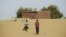 Boys walk on desert sands in the town of Moghtar-Lajjar in west Africa's Sahel region, where the UN says 18 million people risk food insecurity, May 25 2012.