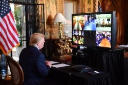 President Donald Trump makes a video call to troops stationed worldwide at the Mar-a-Lago estate in Palm Beach Fla., Dec. 24, 2019.