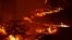 Flames from the Caldor Fire burn through the Eldorado National Forest near Kyburz, California, Aug. 21, 2021.