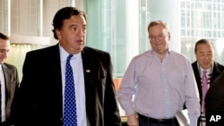 Google's executive chairman Eric Schmidt, second from right, and former New Mexico Gov. Bill Richardson, left, leave after their meeting at a hotel in Beijing, January 7, 2013.