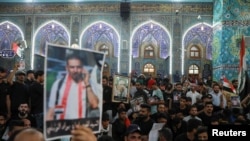 Mourners attend a funeral of Iraqi civil society activist Ehab al-Wazni, who was killed by unidentified gunmen, in Karbala, Iraq, May 9, 2021. 