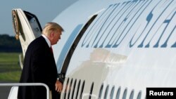 FILE - U.S. President Donald Trump boards Air Force One at Morristown municipal airport, New Jersey, U.S., en route back to Washington after a weekend at the Trump National Golf Club in Bedminster, July 3, 2017. 