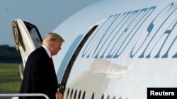 FILE - U.S. President Donald Trump boards Air Force One at Morristown municipal airport, New Jersey, en route back to Washington after a weekend at the Trump National Golf Club in Bedminster, July 3, 2017. 