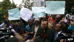 Ugandan anti-gay activists led by controversial Pastor Martin Sempa (C) speak to the press after the constitutional court overturned anti-gay laws in Kampala, August 1, 2014. 