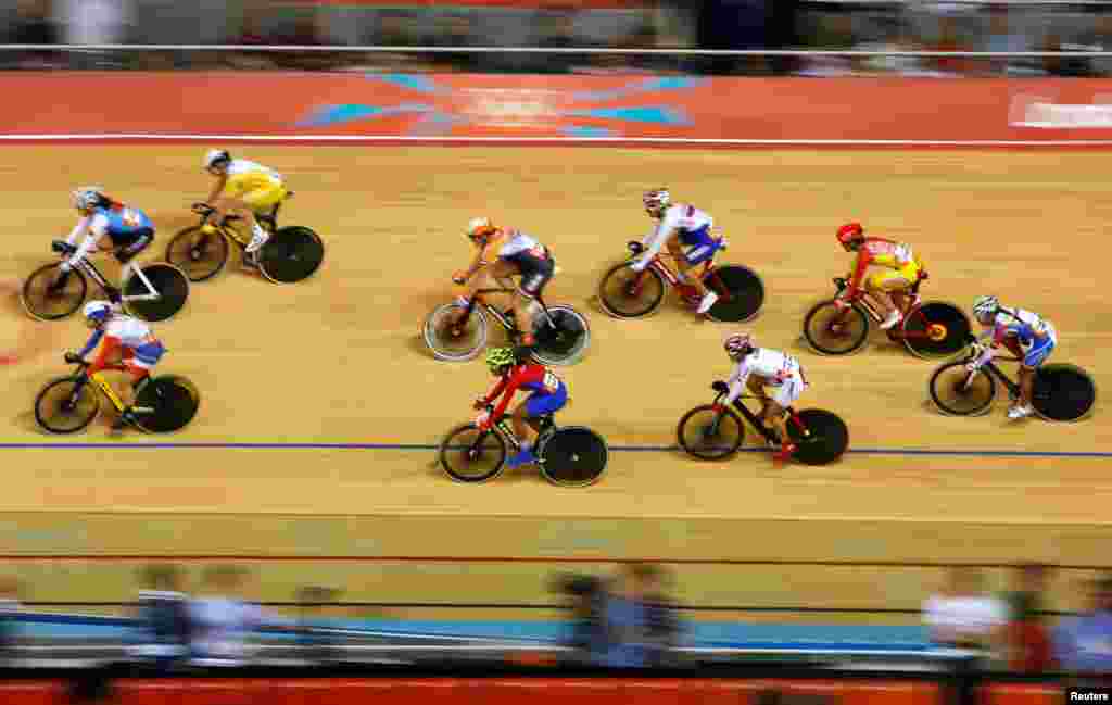 Competitors ride in the track cycling women's omnium 20km points race at the Velodrome.