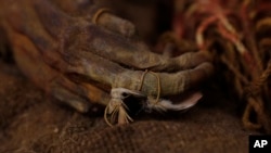 A 500-year-old mummy of an Incan girl is seen clinging to bird feathers, inside a vault at the National Museum of Archaeology in La Paz, Bolivia, Aug. 15, 2019.