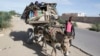 FILE - Somalis are seen leaving the Somali capital Mogadishu, due to hunger, for a refugee camp.