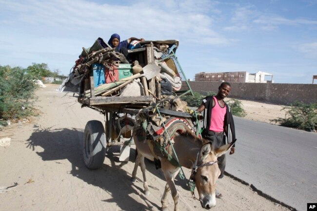 FILE - Somalis are seen leaving the Somali capital Mogadishu, due to hunger, for a refugee camp.