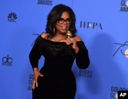 Oprah Winfrey poses in the press room with the Cecil B. DeMille Award at the 75th annual Golden Globe Awards at the Beverly Hilton Hotel on Sunday, Jan. 7, 2018, in Beverly Hills, Calif.