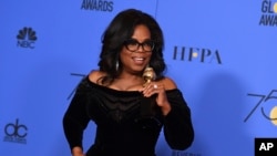 Oprah Winfrey poses in the press room with the Cecil B. DeMille Award at the 75th annual Golden Globe Awards at the Beverly Hilton Hotel on Sunday, Jan. 7, 2018, in Beverly Hills, Calif. 
