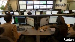 Technicians monitor data flow in the control room of an internet service provider in Tehran, Iran, Feb. 15, 2011. 