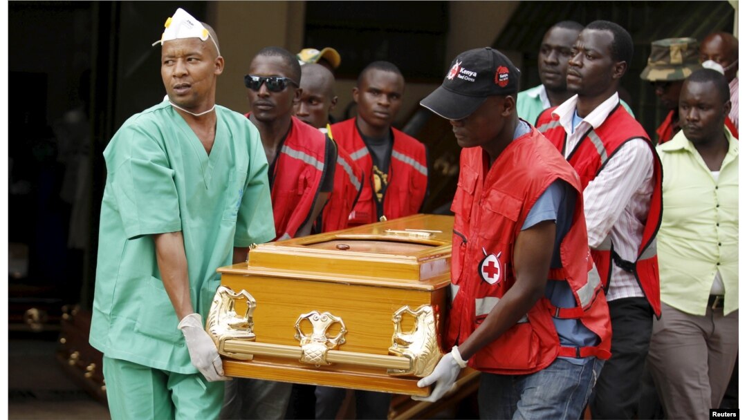 FILE - Mortuary workers and Kenya Red Cross volunteers carry the coffin containing the body of Mildred Yondo, a student killed during an attack by gunmen at Garissa University, from the Chiromo Mortuary in the capital Nairobi, April 8, 2015.