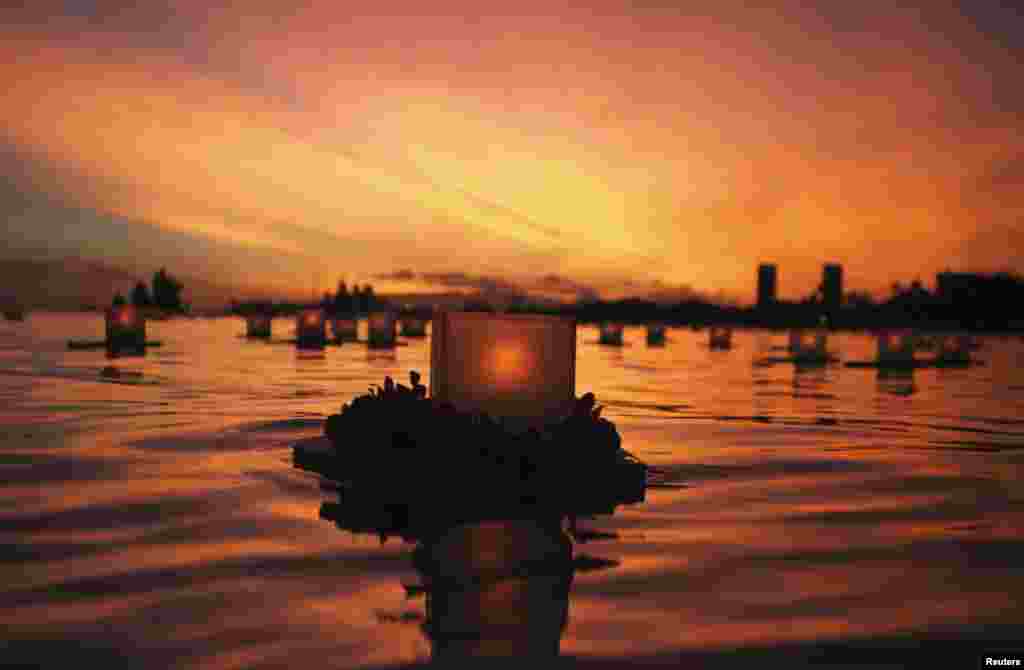 A lantern floats on the water after being released during a ceremony at Ala Moana beach park in Honolulu, Hawaii, held by the Shinnyo-en Buddhist organization, honoring victims of war, famine, and natural disasters on Memorial Day, May 27, 2013.