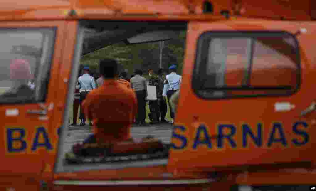 National Search and Rescue Agency crew load coffins containing bodies of the victims from AirAsia Flight 8501, at the airport in Pangkalan Bun, Indonesia, Jan. 8, 2015.