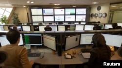 Technicians monitor data flow in the control room of an internet service provider in Tehran, Iran, Feb. 15, 2011. 