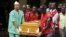 FILE - Mortuary workers and Kenya Red Cross volunteers carry the coffin of a student killed April 2 by gunmen at Garissa University College, from the Chiromo Mortuary in the capital Nairobi, April 8, 2015. 