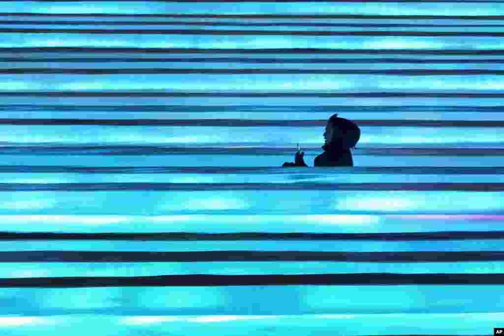 A visitor slides down blocks of ice during the opening ceremony of the Harbin Ice and Snow World in Harbin in China&#39;s Heilongjiang province.