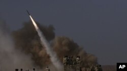 Members of Iran's revolutionary guard launch a surface to surface missile during exercises near the city of Qom in June, 2011 (file photo).