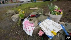 Flowers and messages of support are shown near the International Full Gospel Fellowship church, Thursday, March 18, 2021, in Seattle. The church was one of two in the neighborhood that were hit with anti-Asian graffiti earlier in the week, one of…