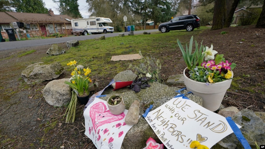Flowers and messages of support are shown near the International Full Gospel Fellowship church, March 18, 2021, in Seattle. The church was one of two in the neighborhood that were hit with anti-Asian graffiti earlier in the week.