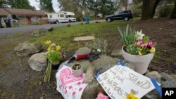 Flowers and messages of support are shown near the International Full Gospel Fellowship church, March 18, 2021, in Seattle. The church was one of two in the neighborhood that were hit with anti-Asian graffiti earlier in the week.