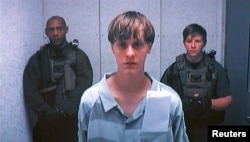 Dylann Storm Roof appears by closed-circuit television at his bond hearing in Charleston, South Carolina June 19, 2015 in a still image from video. A 21-year-old white man has been charged with nine counts of murder in connection with an attack on a histo